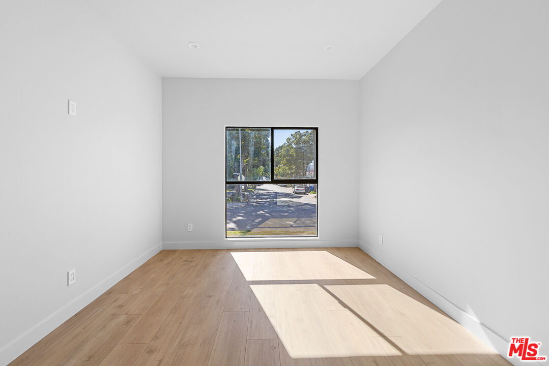 7229 Willoughby Avenue, Unit 8 Los Angeles, CA 90046 - Photo 9 of 14 a view of a room with wooden floor and large windows