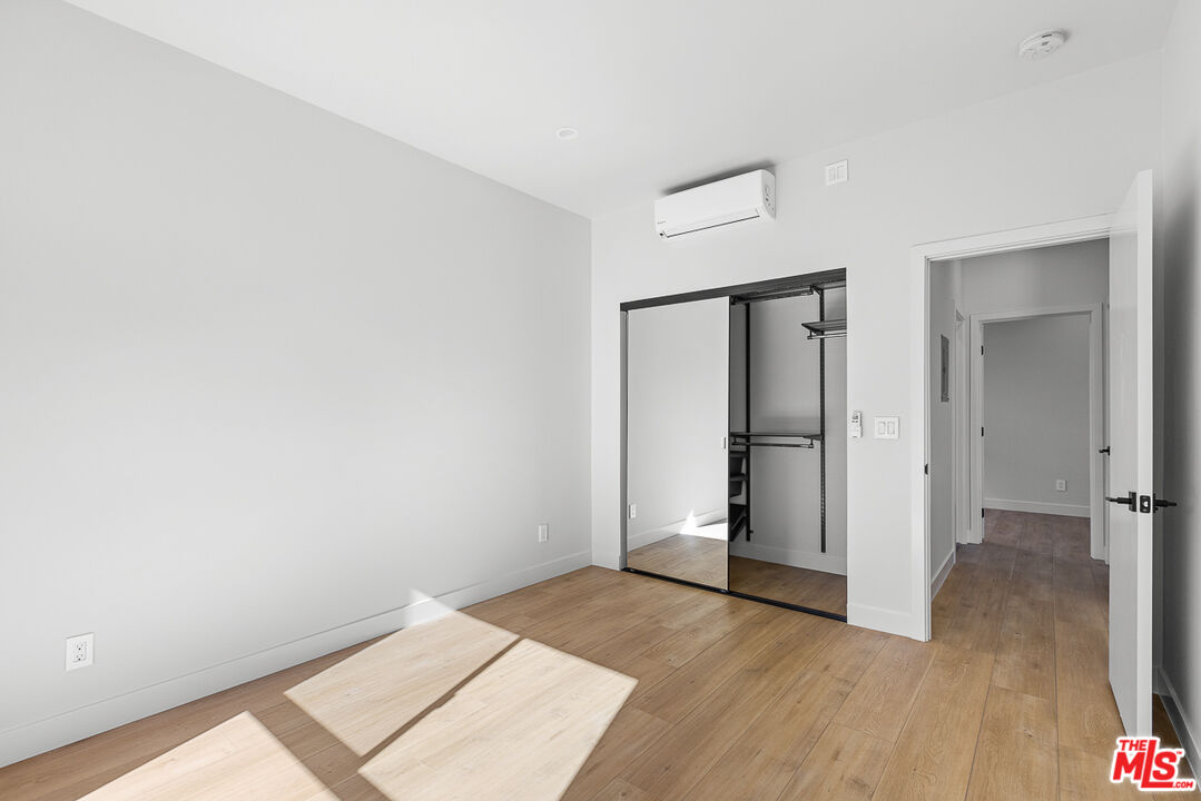 7229 Willoughby Avenue, Unit 8 Los Angeles, CA 90046 - Photo 10 of 14 an empty room with wooden floor