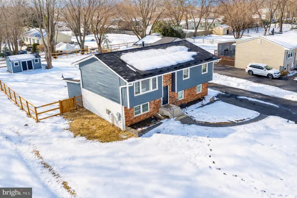 a view of a house with cars parked