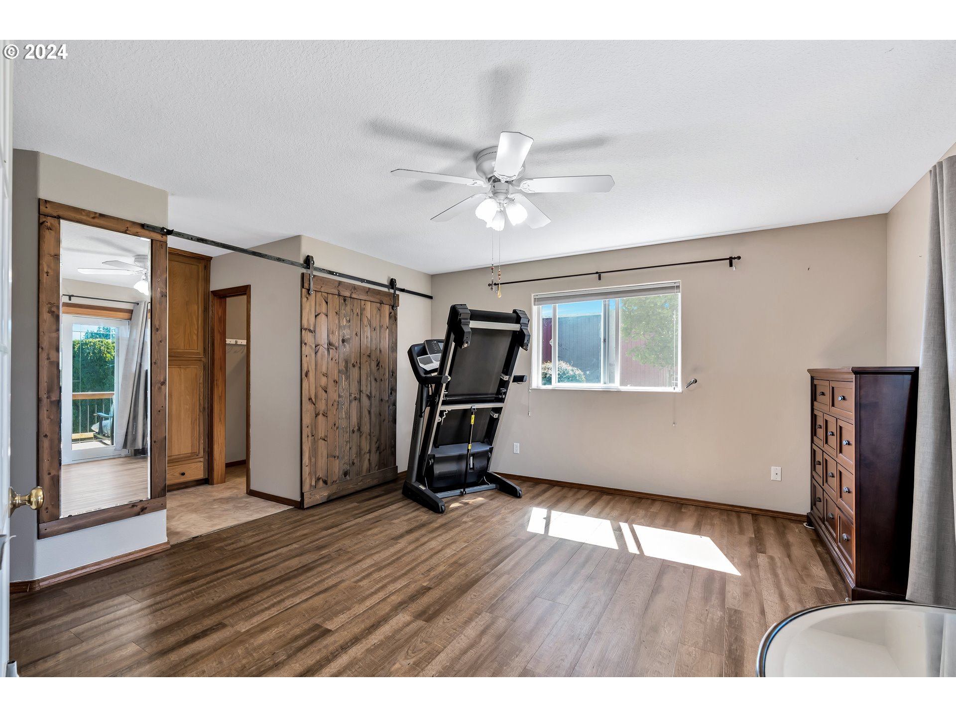 26400 Northeast 29th Avenue Ridgefield, WA 98642 - Photo 21 of 48 a view of an empty room with wooden floor and a window