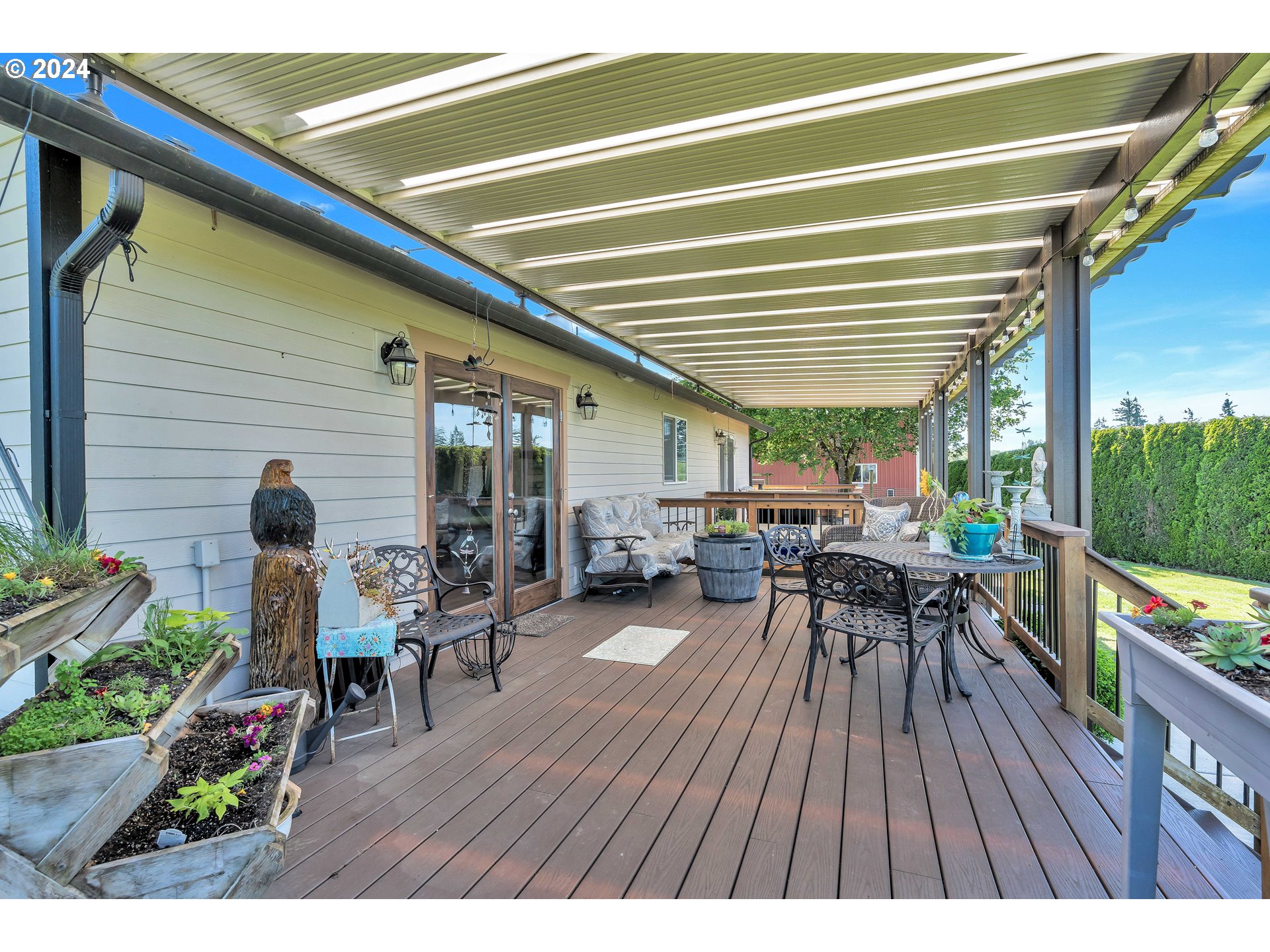 26400 Northeast 29th Avenue Ridgefield, WA 98642 - Photo 31 of 48 a view of a patio with table and chairs potted plants with wooden floor and fence