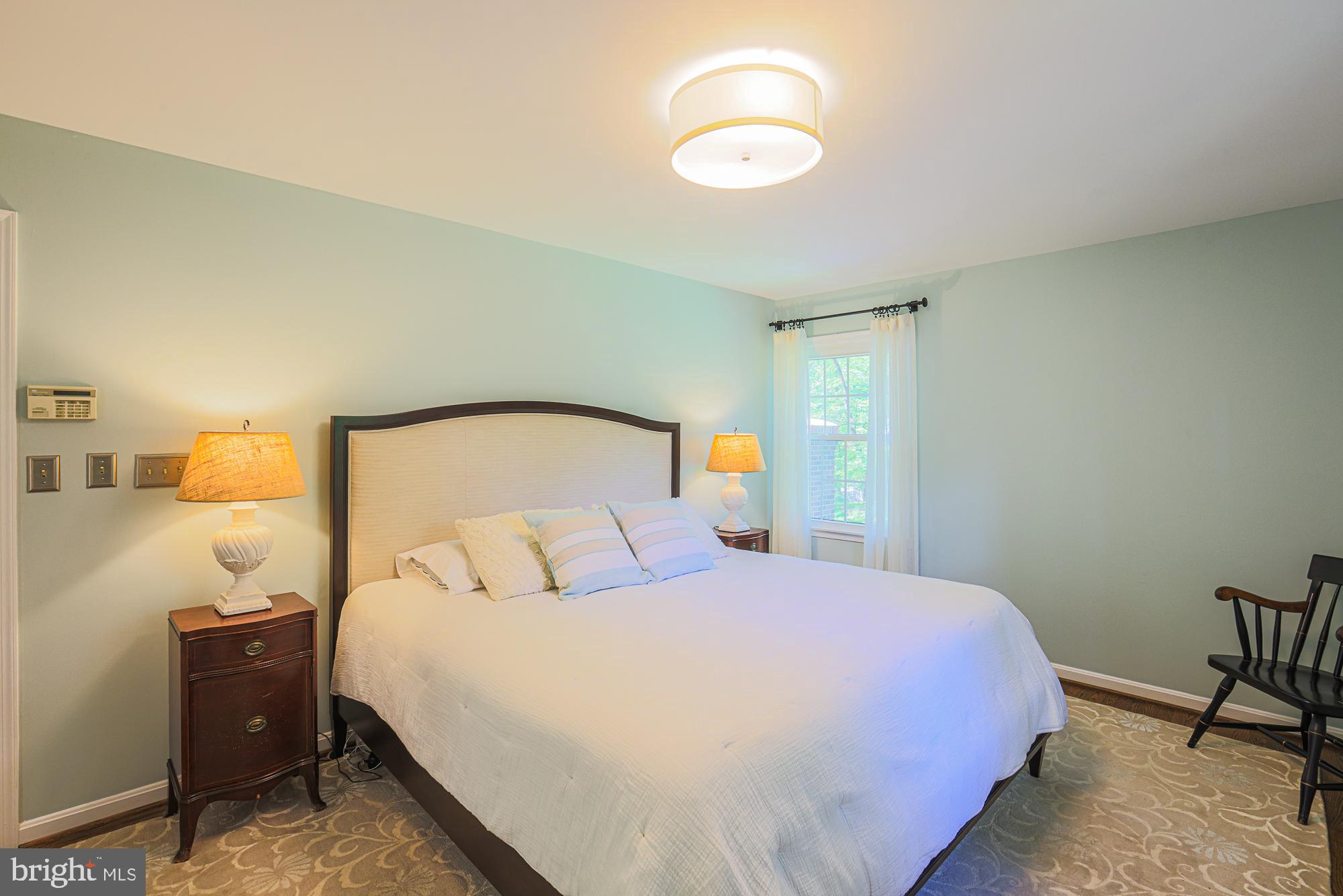 1516 Pinnacle Road Baltimore, MD 21286 - Photo 28 of 53 a bedroom with a bed and a lamp