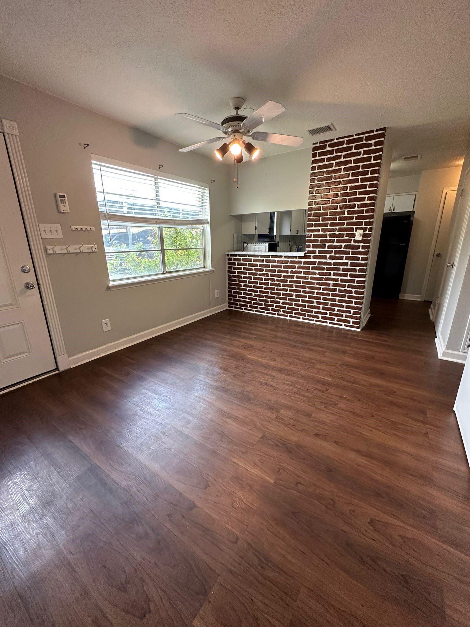 7305 South Gessner Road Houston, TX 77036 - Photo 15 of 24 wooden floor in an empty room with a window
