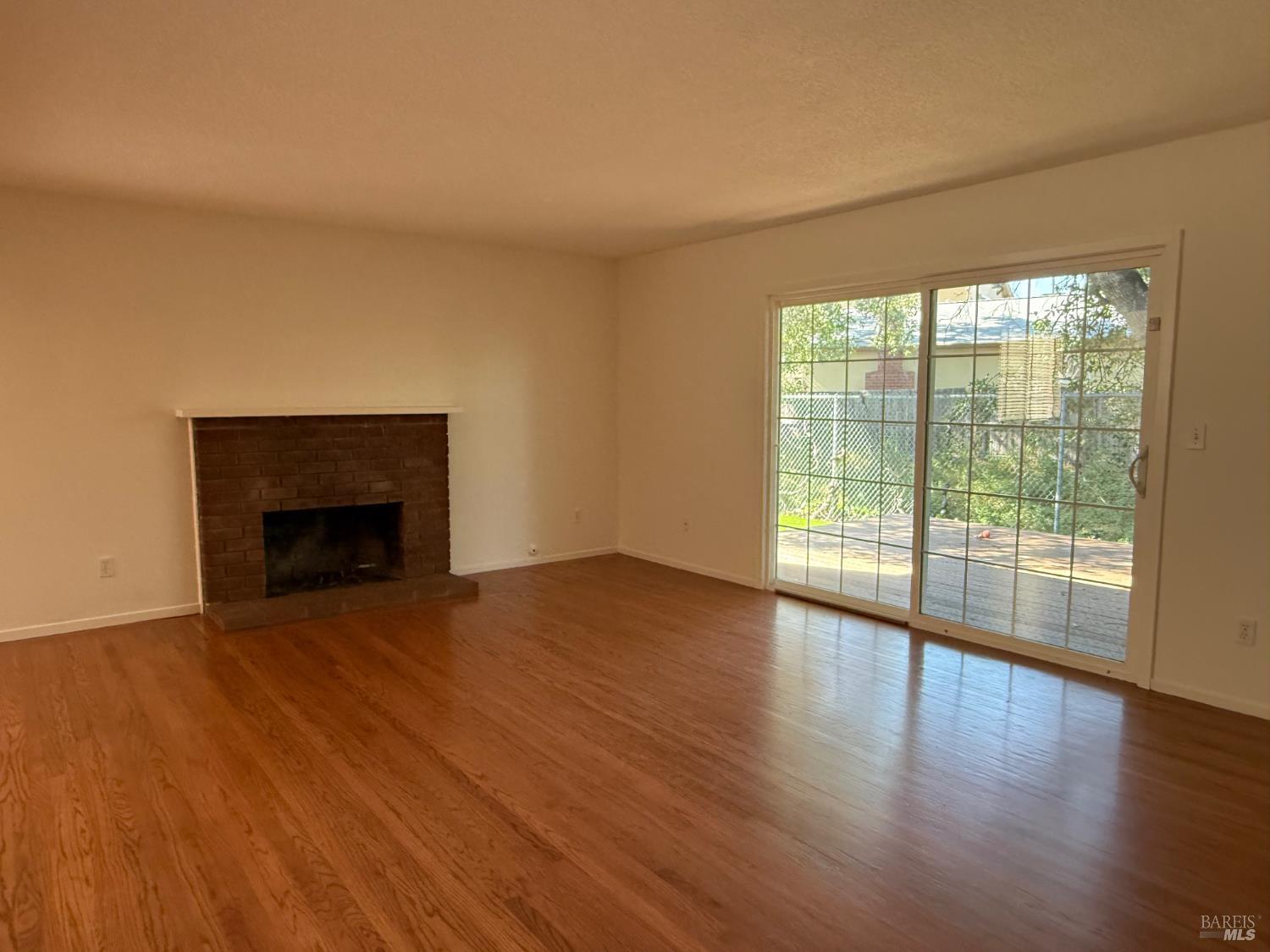 2553 Cactus Avenue Santa Rosa, CA 95405 - Photo 3 of 15 a view of an empty room with wooden floor and a window
