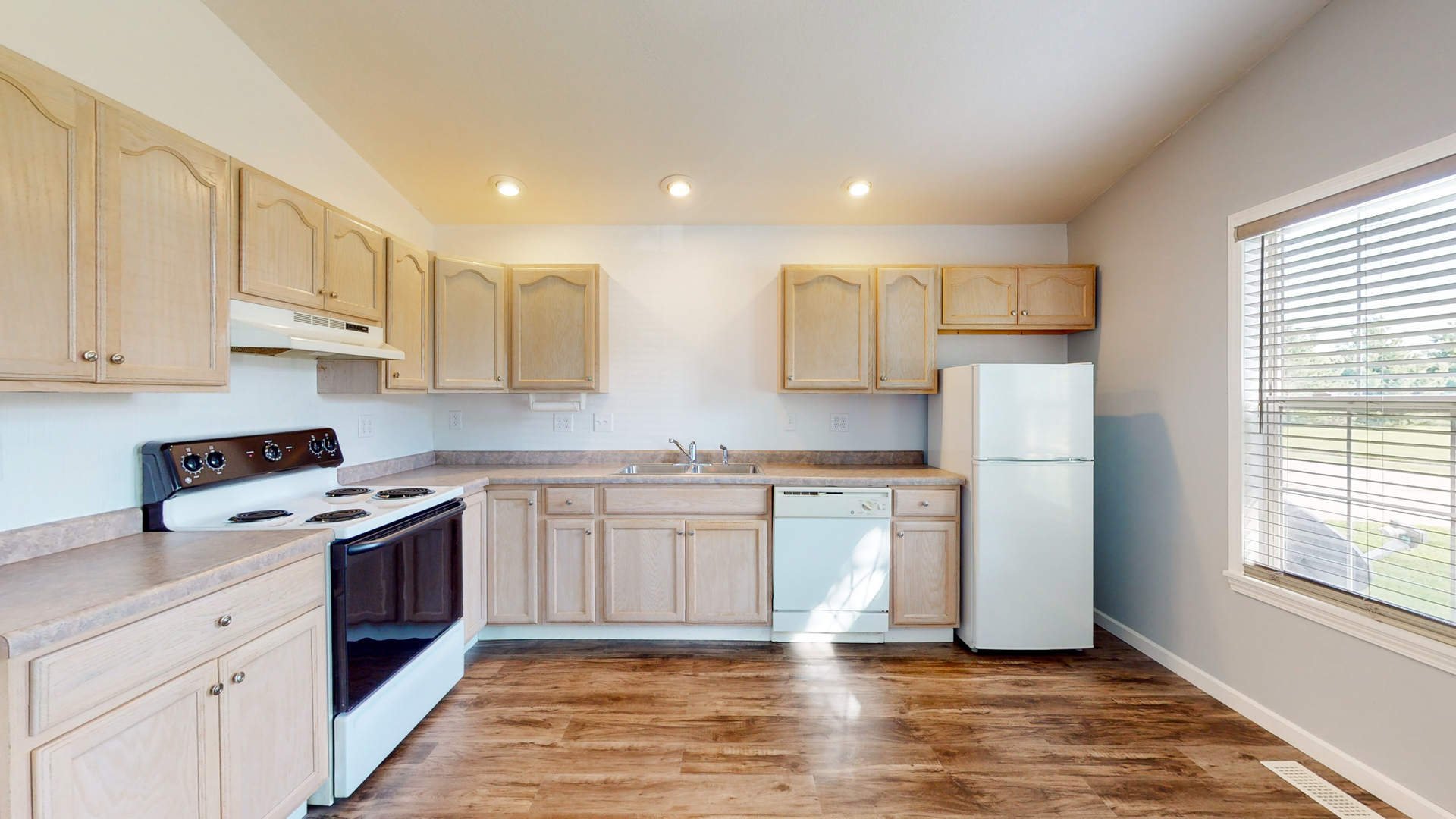 809 East 14th Street Georgetown, IL 61846 - Photo 6 of 52 a kitchen with stainless steel appliances granite countertop a refrigerator sink and white cabinets