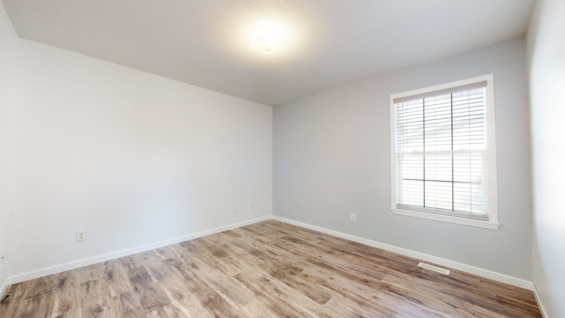 809 East 14th Street Georgetown, IL 61846 - Photo 9 of 52 an empty room with wooden floor and windows