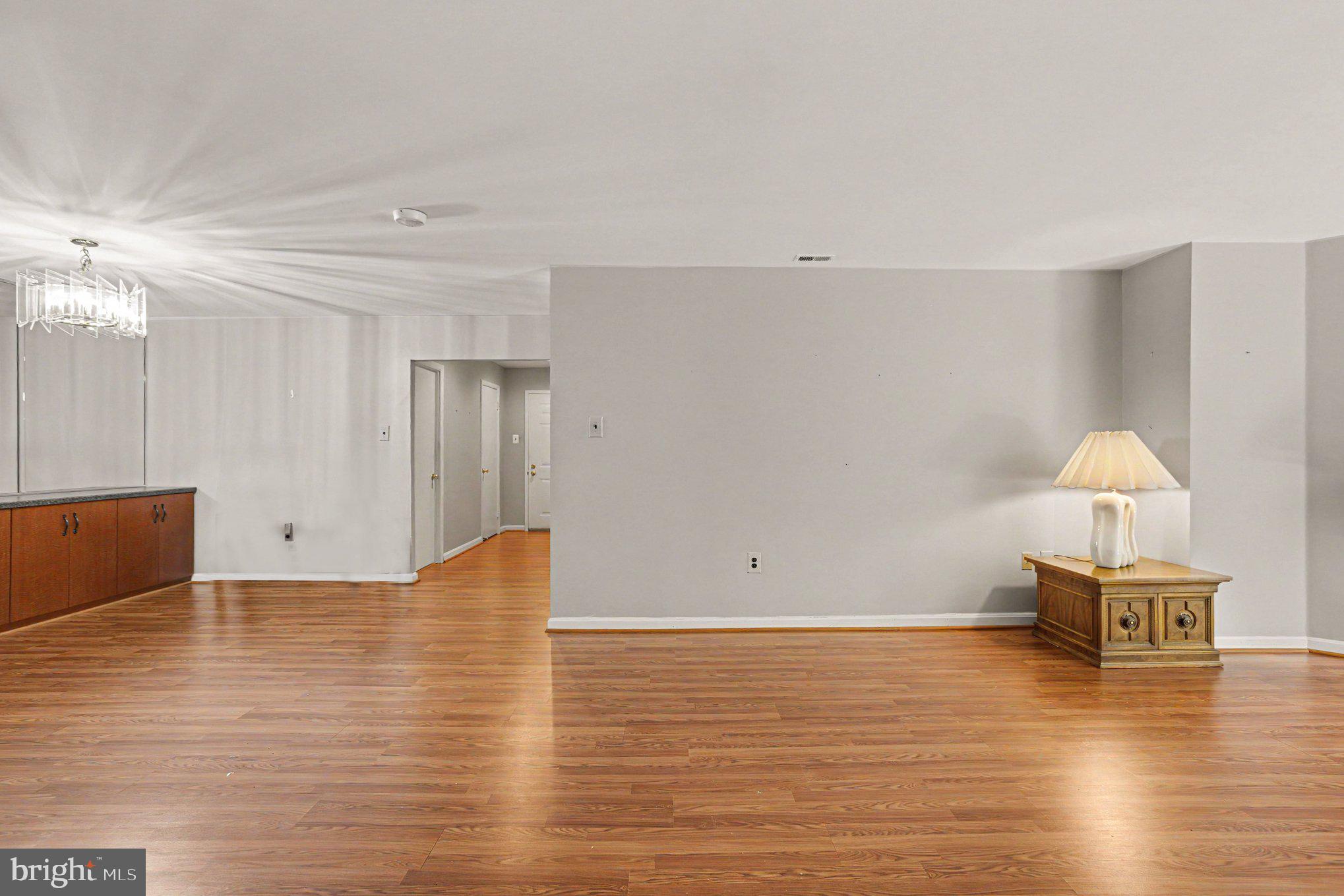 3021 Fallstaff Road, Unit 208B Baltimore, MD 21209 - Photo 4 of 25 a view of kitchen and empty room with wooden floor