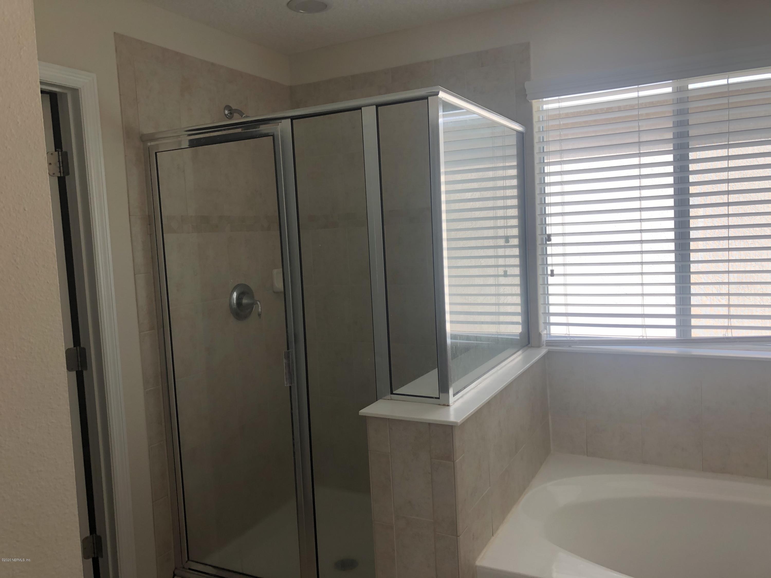 3782 Chasing Falls Road Orange Park, FL 32065 - Photo 14 of 22 a bathroom with a shower and a tub