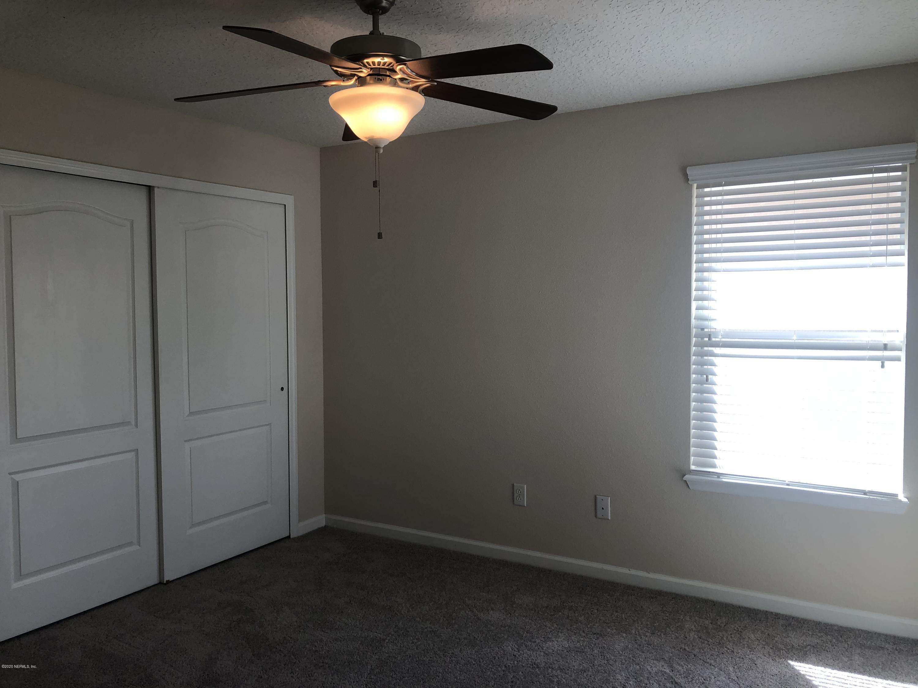 3782 Chasing Falls Road Orange Park, FL 32065 - Photo 17 of 22 an empty room with windows and fan