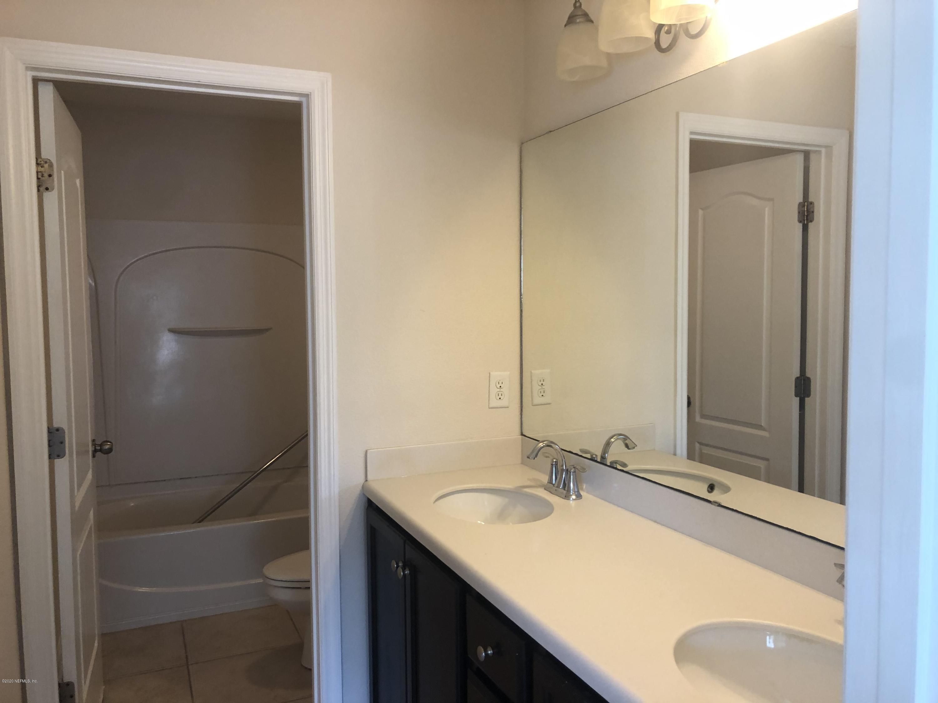 3782 Chasing Falls Road Orange Park, FL 32065 - Photo 18 of 22 a bathroom with a sink and a mirror