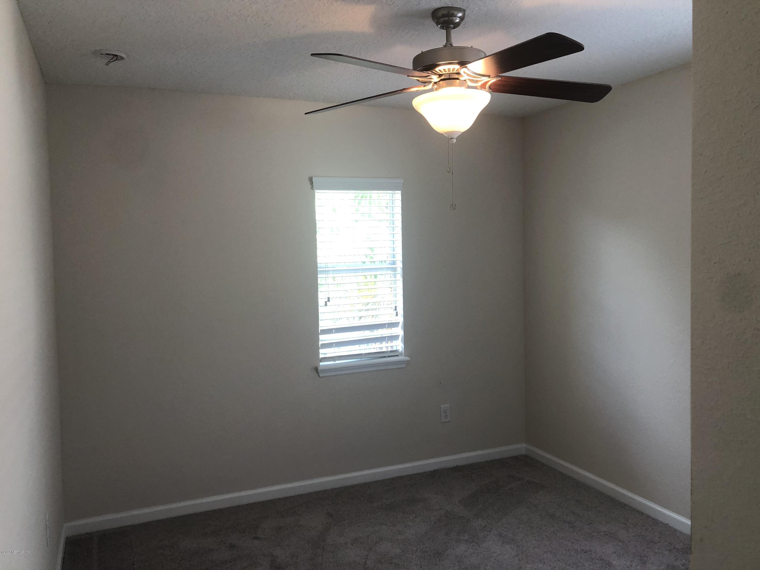 3782 Chasing Falls Road Orange Park, FL 32065 - Photo 20 of 22 en empty room with windows and chandelier fan