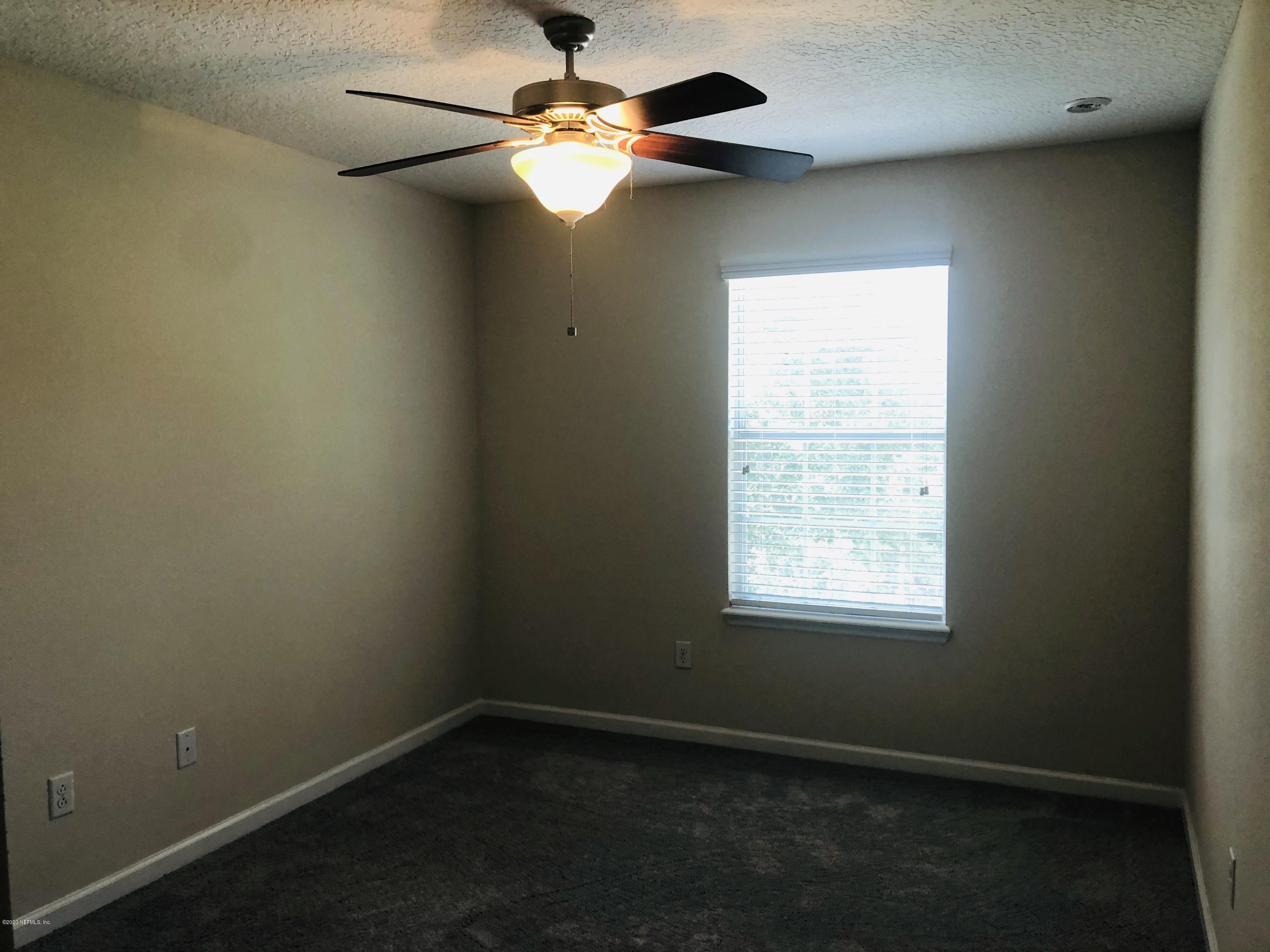 3782 Chasing Falls Road Orange Park, FL 32065 - Photo 21 of 22 an empty room with a window and a fan