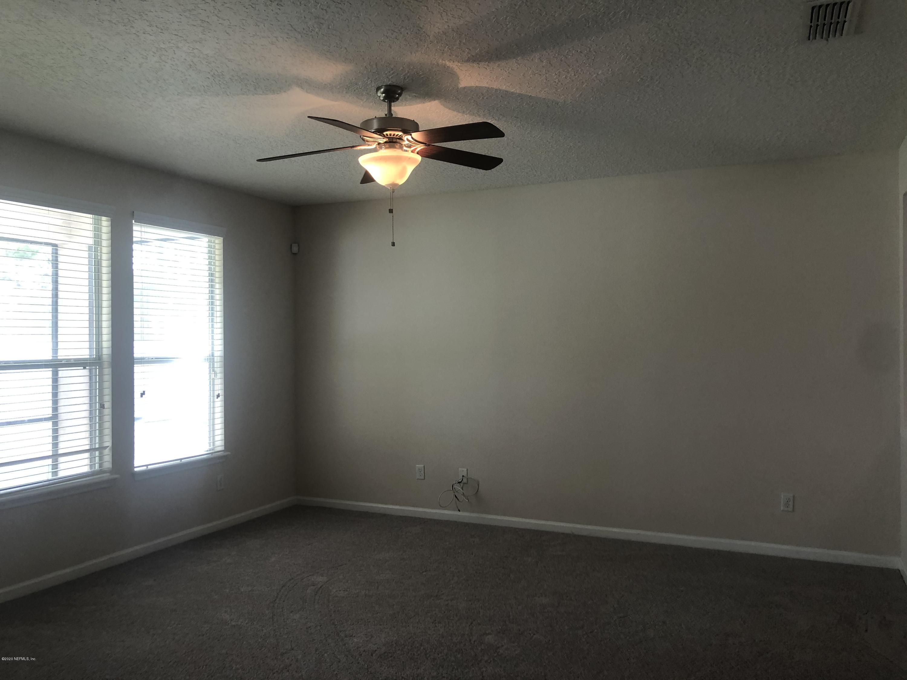 3782 Chasing Falls Road Orange Park, FL 32065 - Photo 3 of 22 an empty room with windows and fan