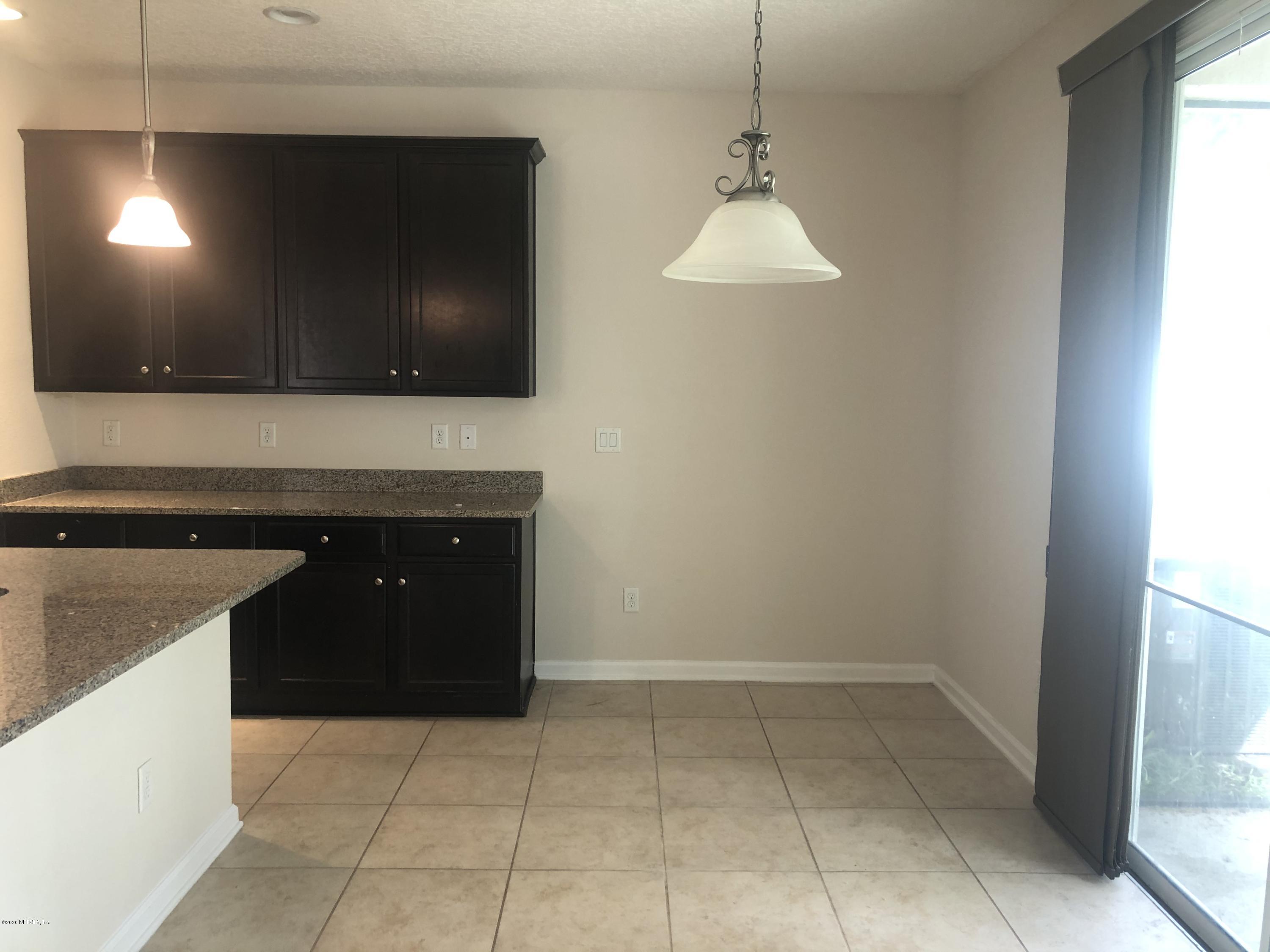 3782 Chasing Falls Road Orange Park, FL 32065 - Photo 6 of 22 a kitchen with a sink a microwave and cabinets