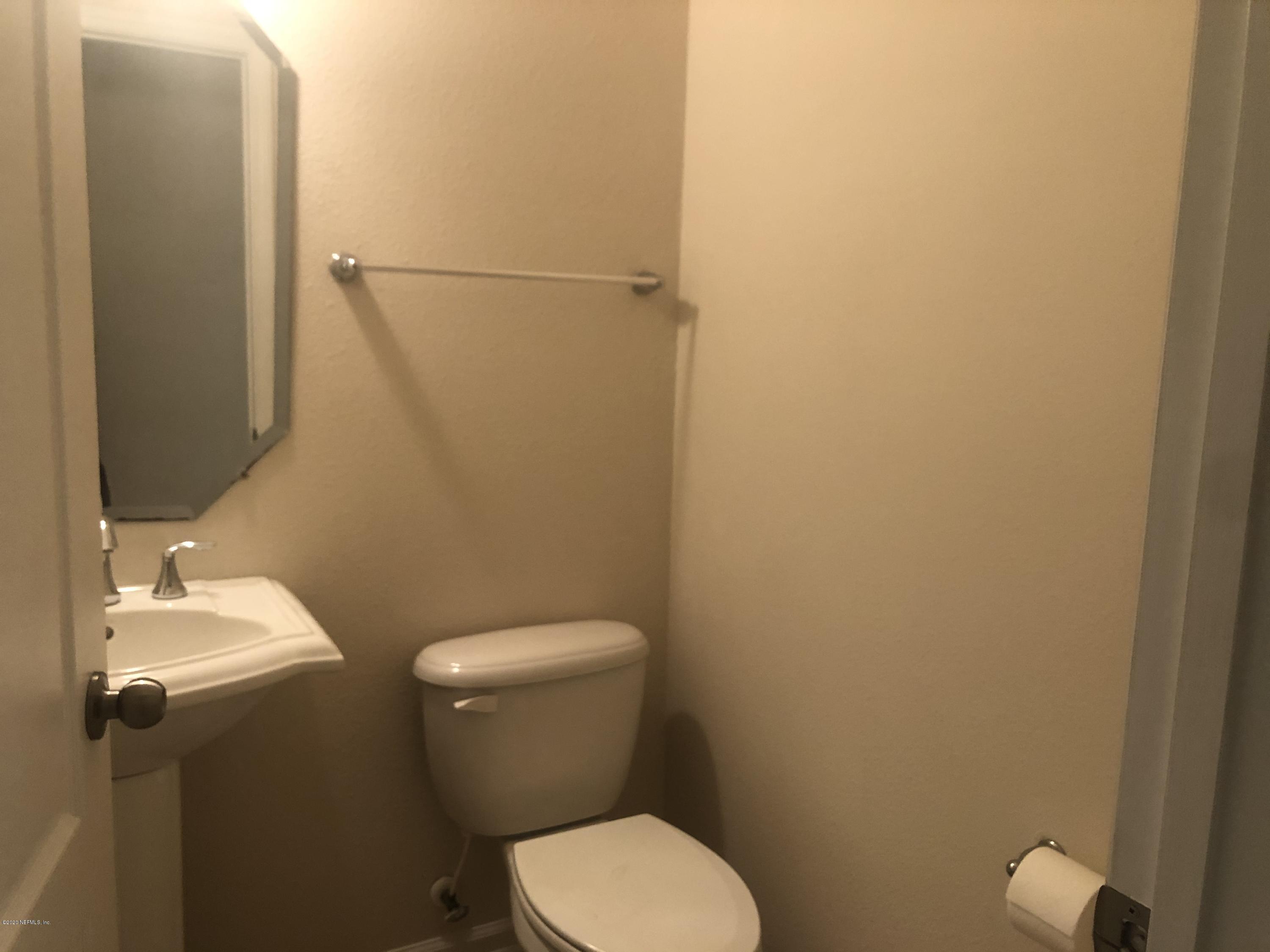 3782 Chasing Falls Road Orange Park, FL 32065 - Photo 9 of 22 a white toilet sitting next to a white sink and vanity