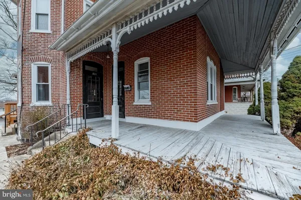 a view of a house with a door and wooden walls
