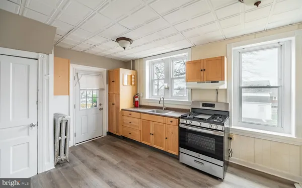 a kitchen with stainless steel appliances granite countertop a stove and a refrigerator
