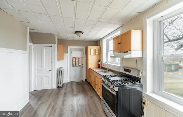 a kitchen with stainless steel appliances a stove a refrigerator and cabinets