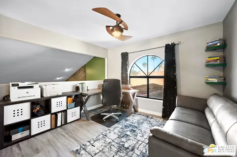 a work room with furniture and wooden floor