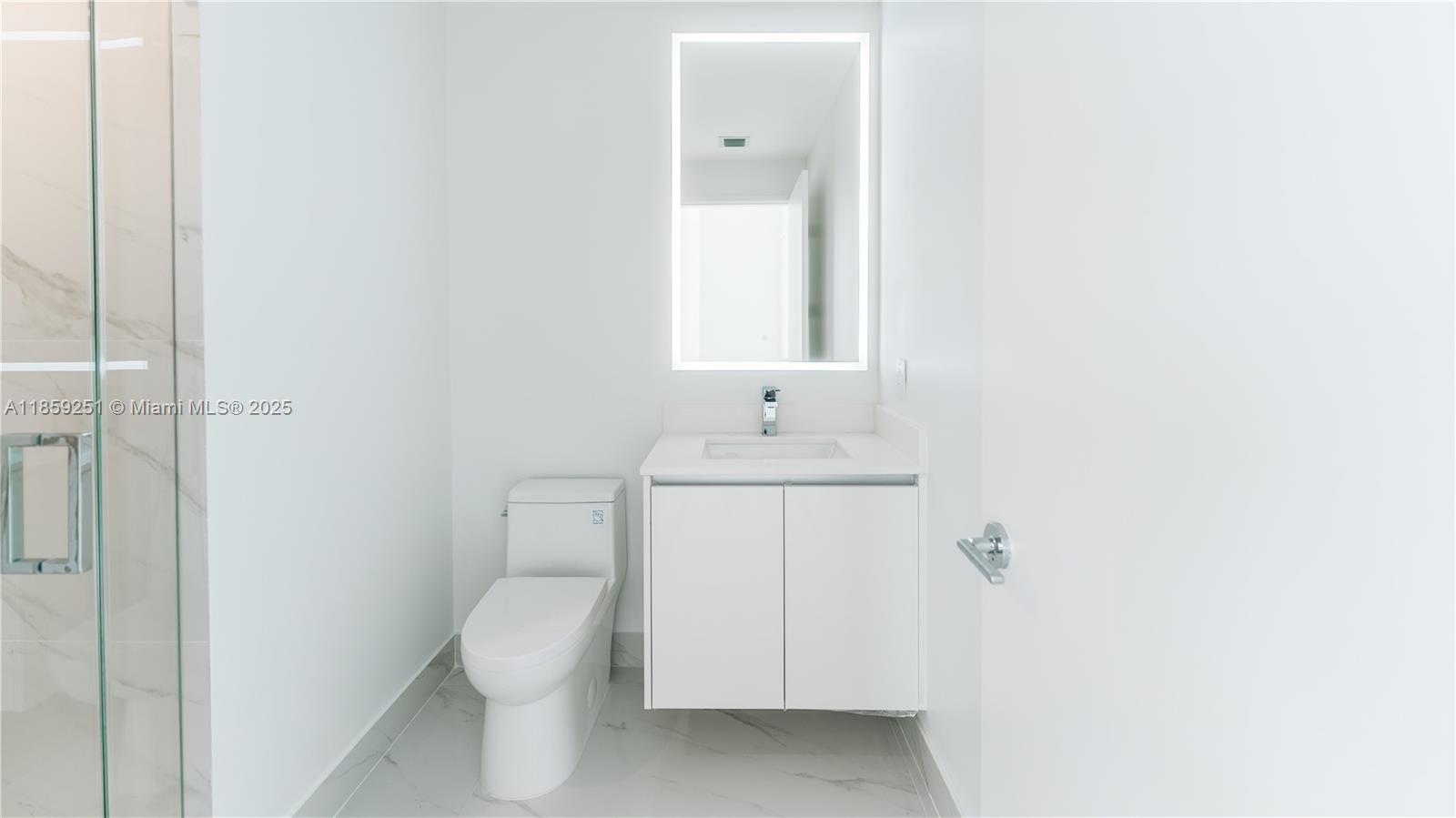 700 Northeast 24th Street, Unit 4101 Miami, FL 33137 - Photo 51 of 68 a bathroom with a toilet sink and mirror