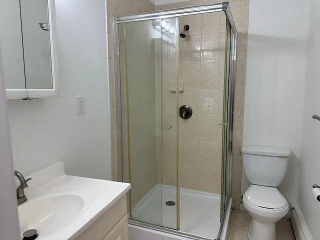 a bathroom with a shower toilet and sink