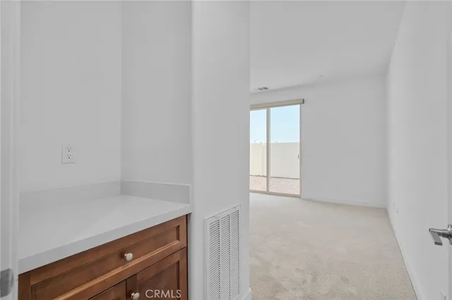 a bedroom with a bed and painting on the wall