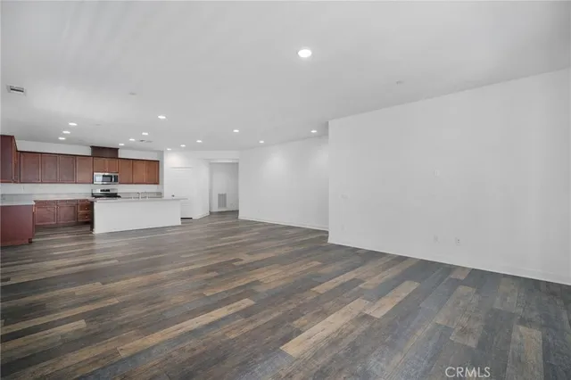 a view of kitchen with wooden floor and kitchen appliances