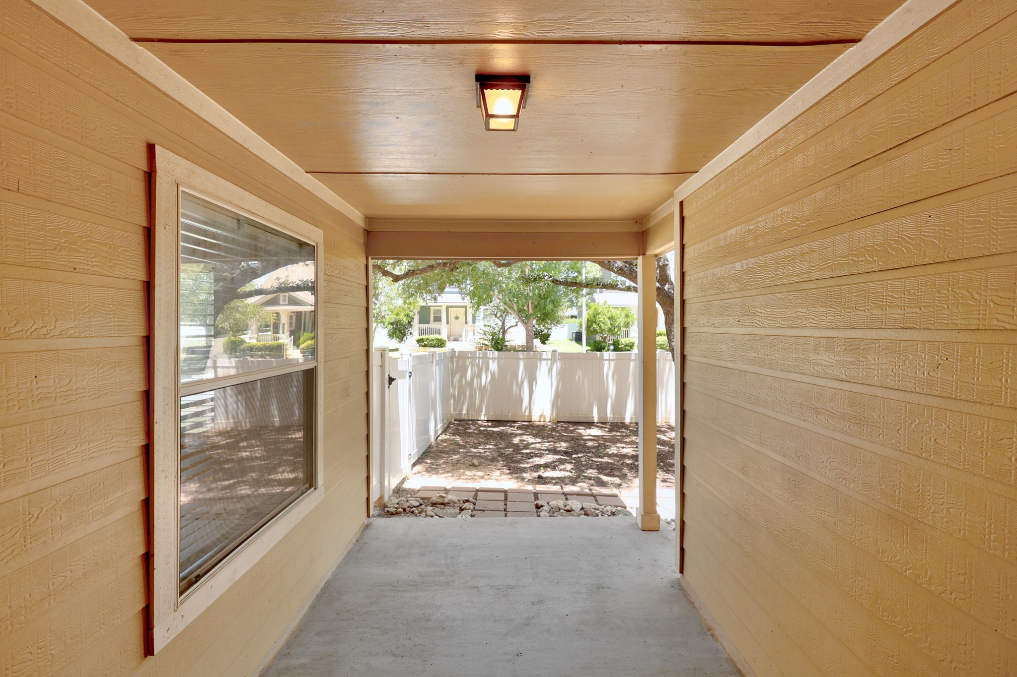 1818 Lost Maples Loop Cedar Park, TX 78613 - Photo 26 of 38 A well-lit, covered walkway guides guests to a private outdoor space.