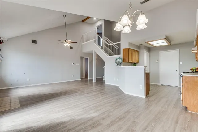 a view of a kitchen with a microwave and a wooden floor