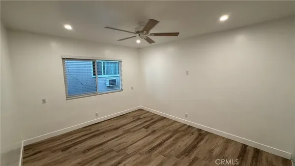 a view of room with wooden floor