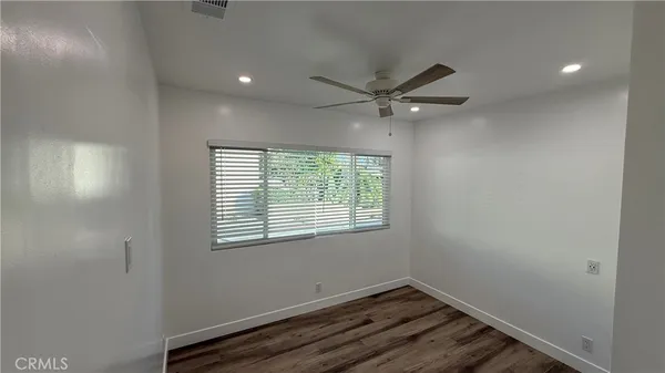 a view of room with wooden floor