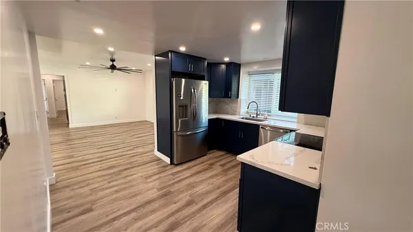 a kitchen with a sink a counter top space and stainless steel appliances