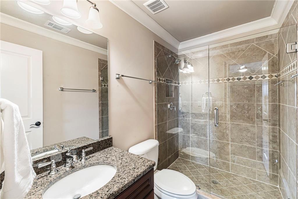3751 Paces Lookout Circle Southeast Atlanta, GA 30339 - Photo 25 of 39 a bathroom with a sink toilet vanity and shower
