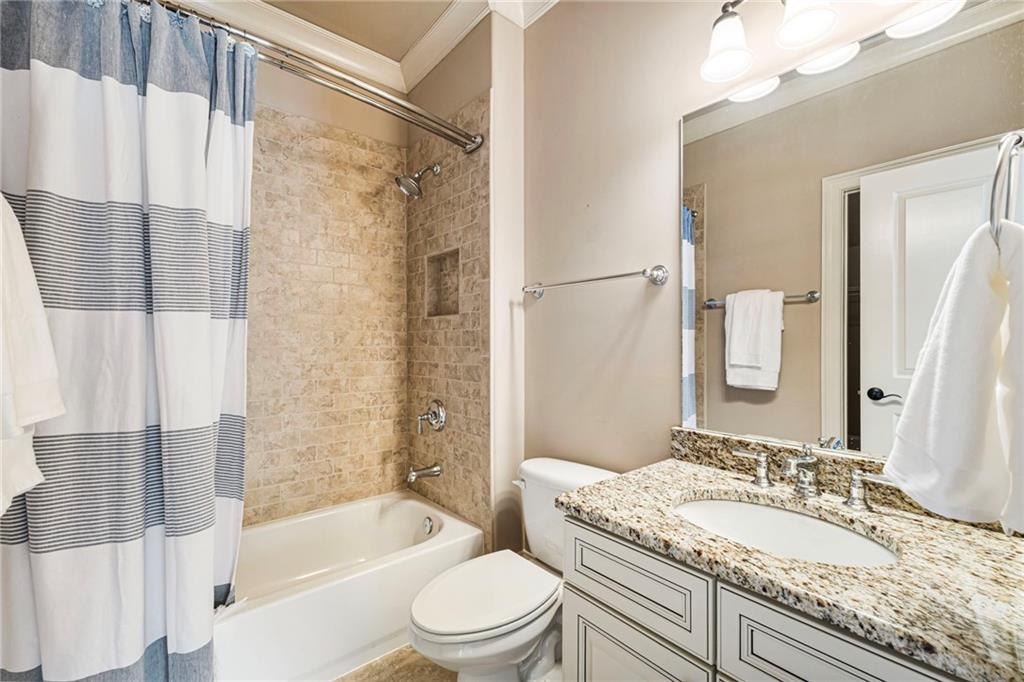 3751 Paces Lookout Circle Southeast Atlanta, GA 30339 - Photo 34 of 39 a bathroom with a granite countertop tub toilet sink and mirror