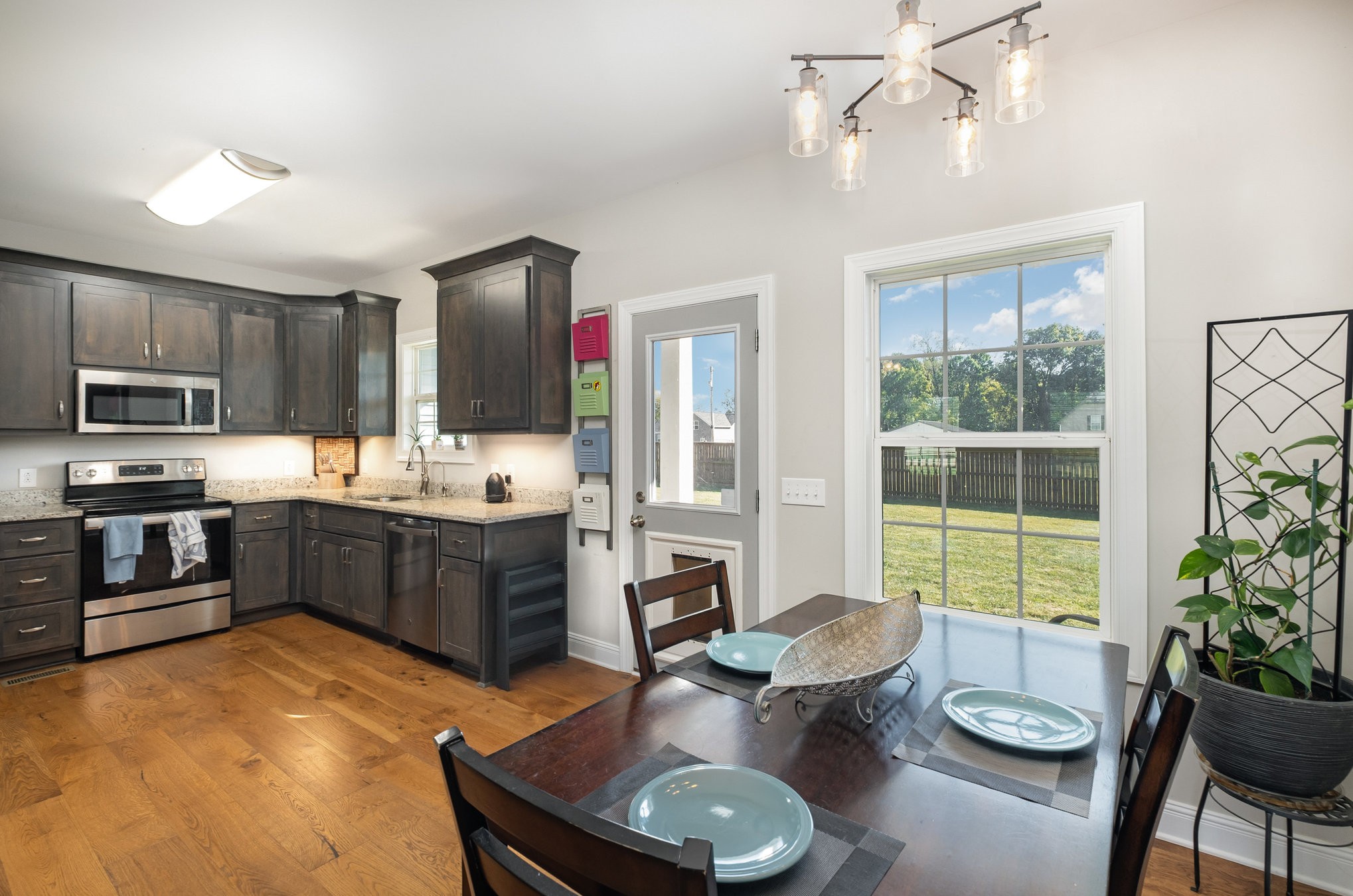 8903 Covington Road White House, TN 37188 - Photo 12 of 36 a kitchen with sink refrigerator dining table and chairs