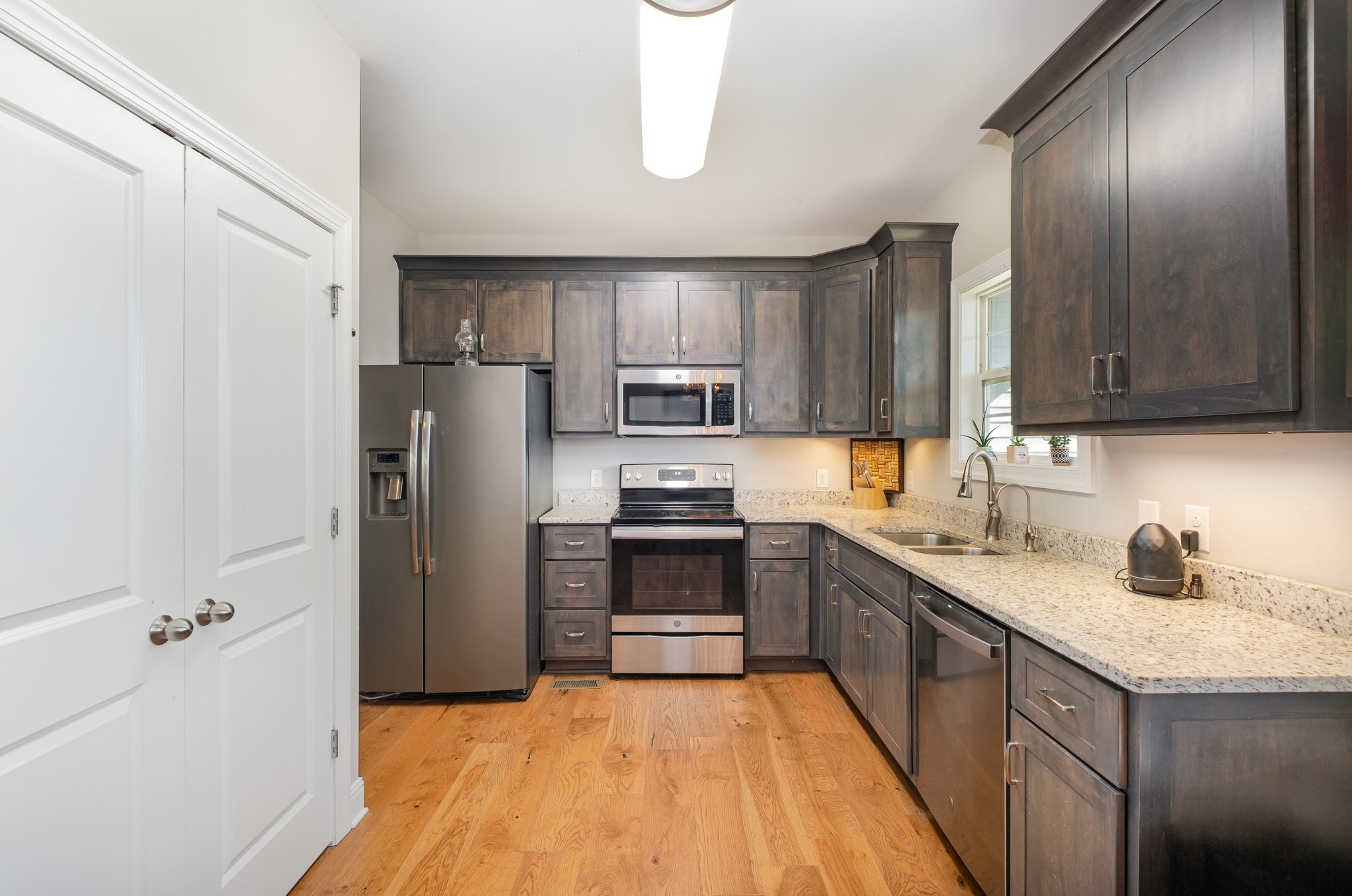 8903 Covington Road White House, TN 37188 - Photo 14 of 36 a kitchen with granite countertop a refrigerator stove and sink