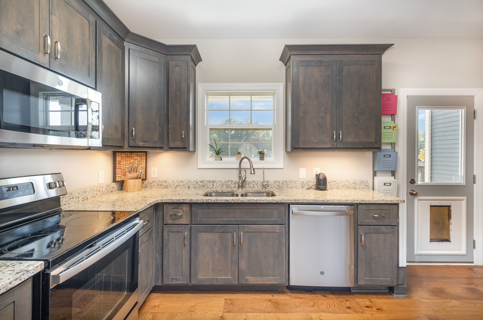 8903 Covington Road White House, TN 37188 - Photo 15 of 36 a kitchen with stainless steel appliances granite countertop a sink stove and cabinets