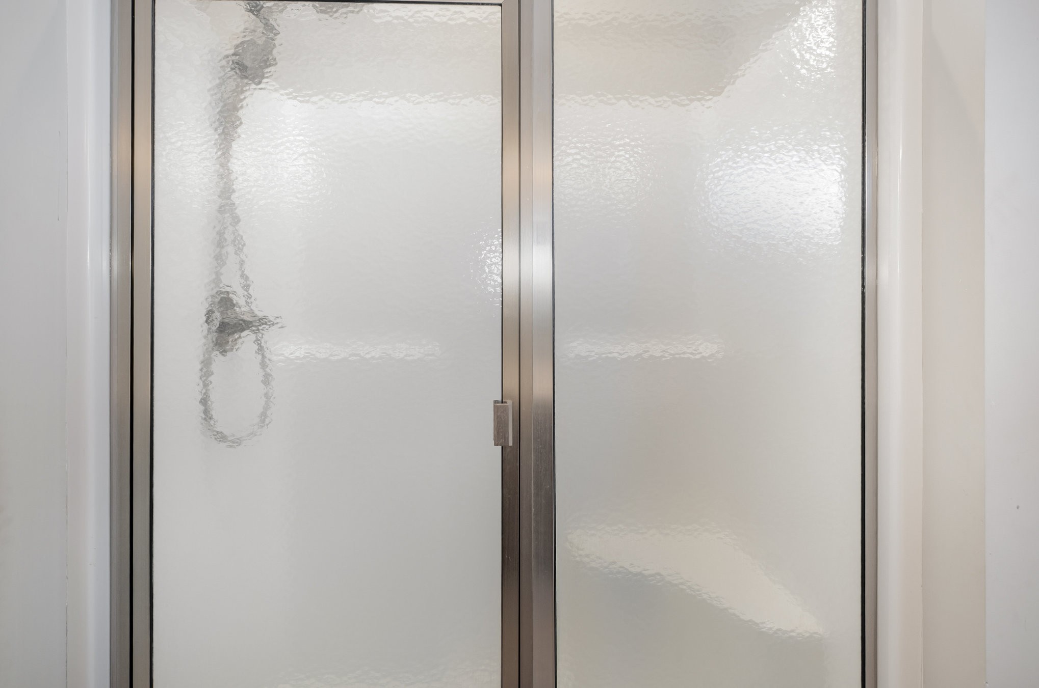 8903 Covington Road White House, TN 37188 - Photo 20 of 36 a bathroom with a glass shower door