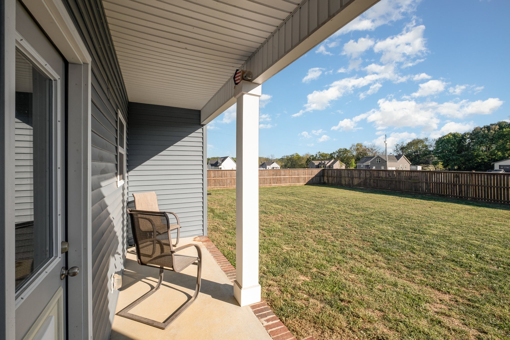 8903 Covington Road White House, TN 37188 - Photo 28 of 36 a view of a patio with table and chairs under an umbrella with wooden fence