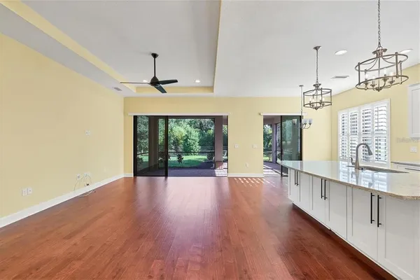 a large kitchen with dishwasher a refrigerator and wooden floor