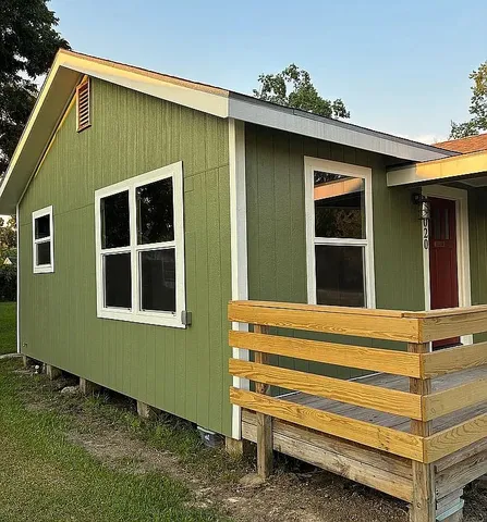a front view of a house with a garden
