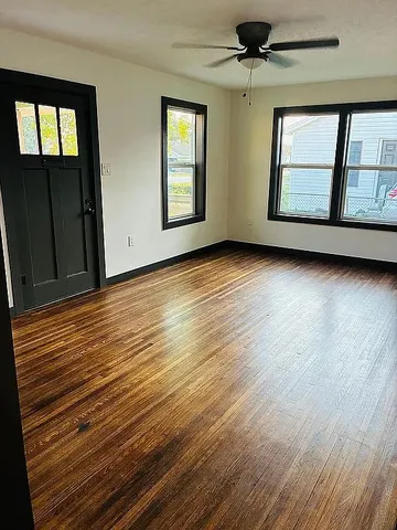 wooden floor in an empty room with a window