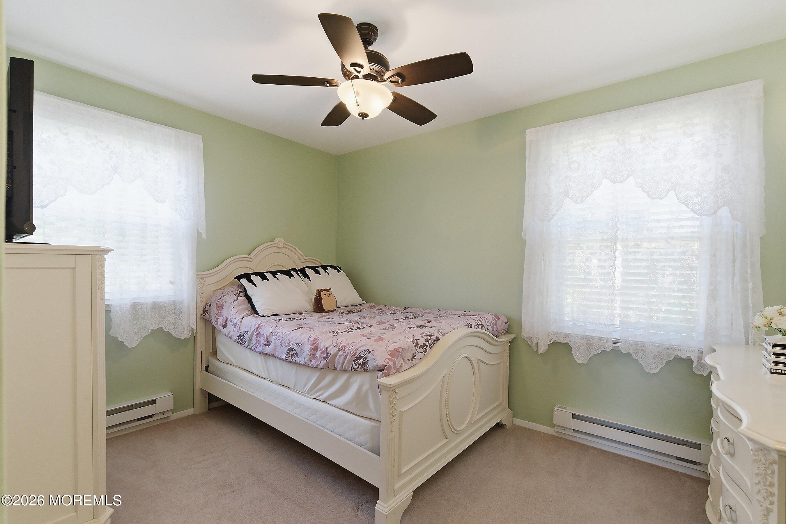8 Hummingbird Lane Whiting, NJ 08759 - Photo 12 of 41 a bedroom with a bed and a ceiling fan