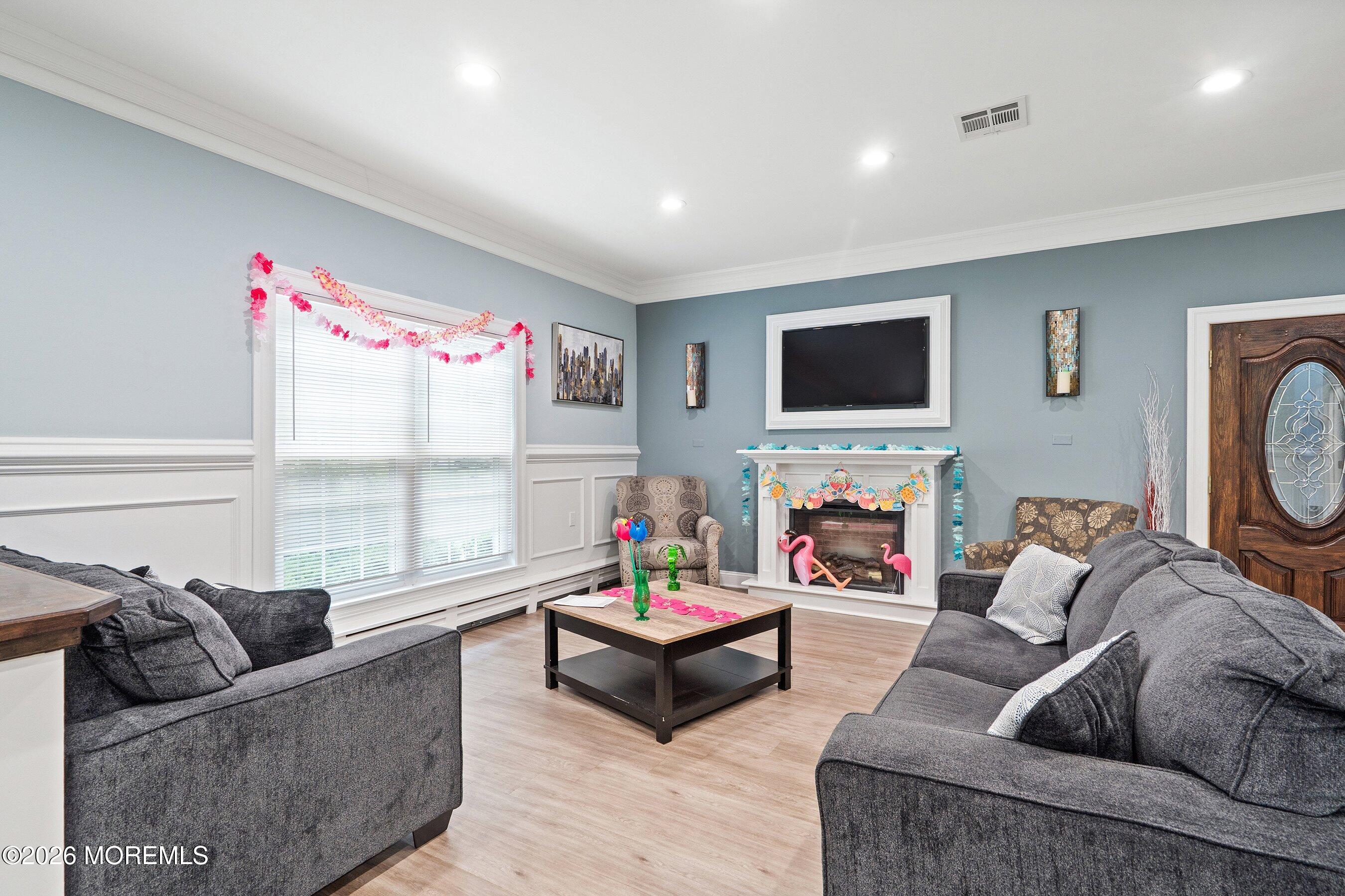 8 Hummingbird Lane Whiting, NJ 08759 - Photo 30 of 41 a living room with furniture a flat screen tv and a floor to ceiling window
