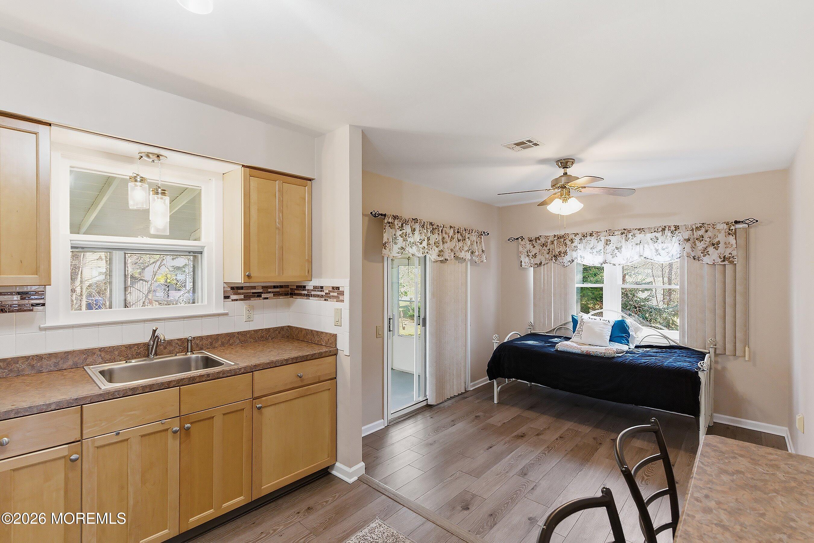 8 Hummingbird Lane Whiting, NJ 08759 - Photo 6 of 41 a kitchen with a table chairs sink and cabinets