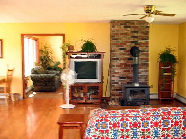 417 Canaan Road Clinton, ME 04927 - Photo 3 of 20 Living room with wood stove