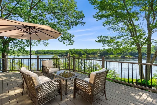 a view of a balcony with furniture and wooden floor