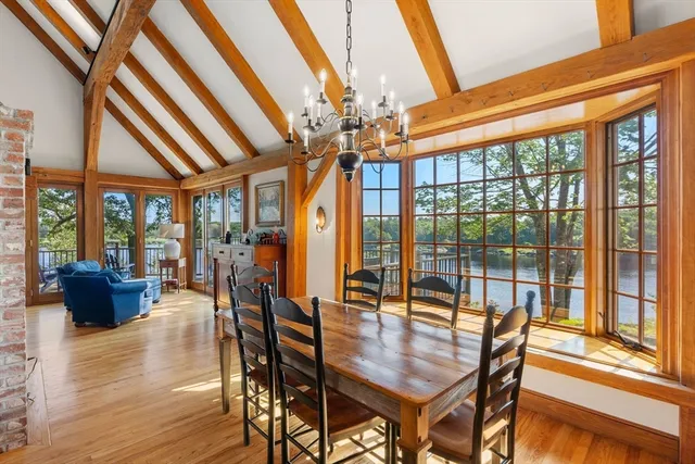 a dining room with furniture wooden floor and a chandelier