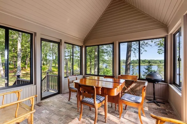 a view of a dining room with furniture large windows and wooden floor