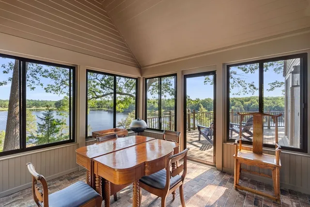 a dining room with furniture window and outside view